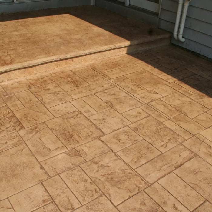 Concrete patio with brick-pattern stamped design showing two section levels